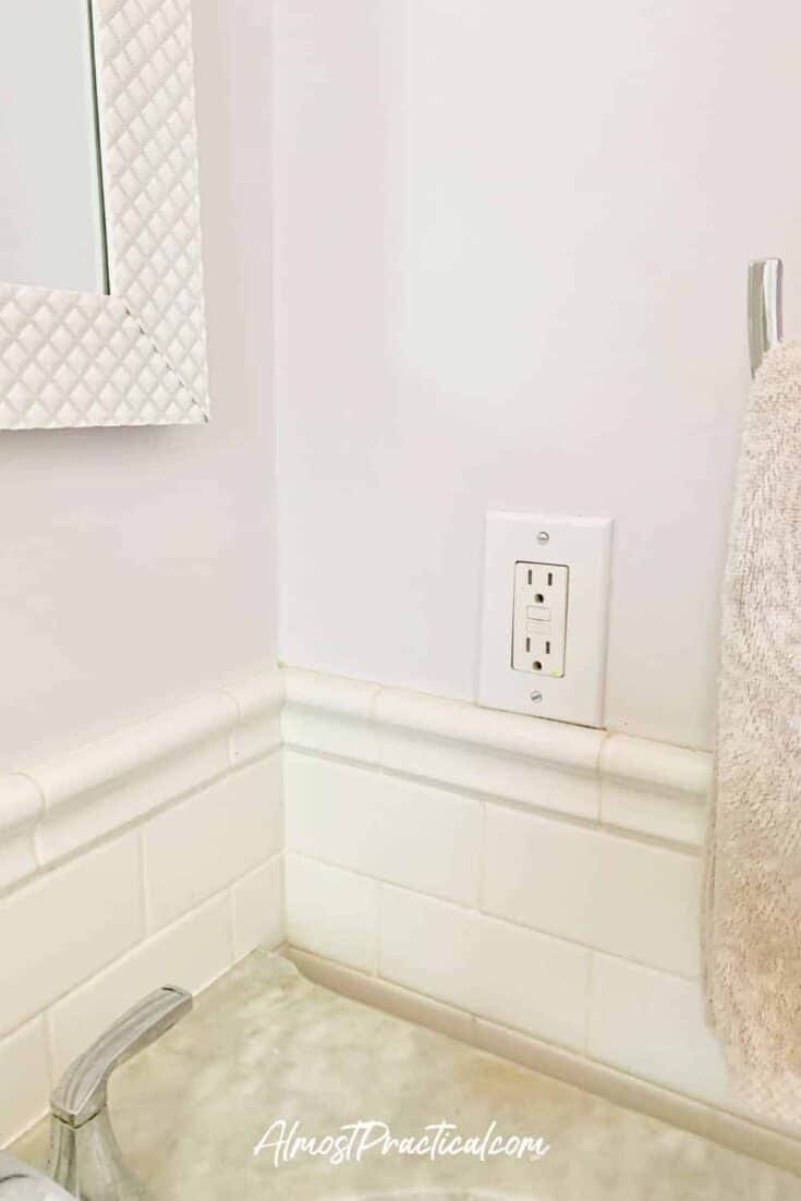wall outlet positioning over tile wainscoting in bathroom