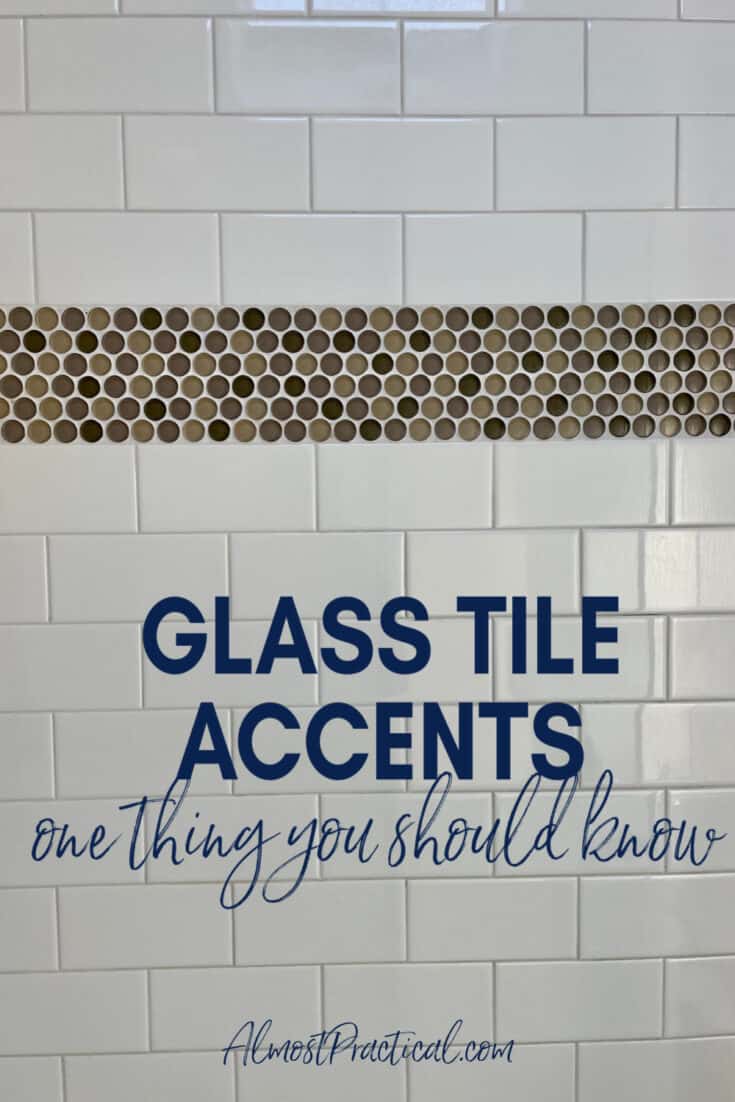 shower wall with white subway tile and a stripe of glass tile accents