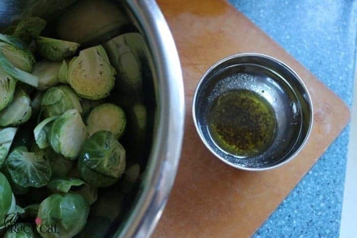 Mix up the olive oil for the roasted brussels sprouts.
