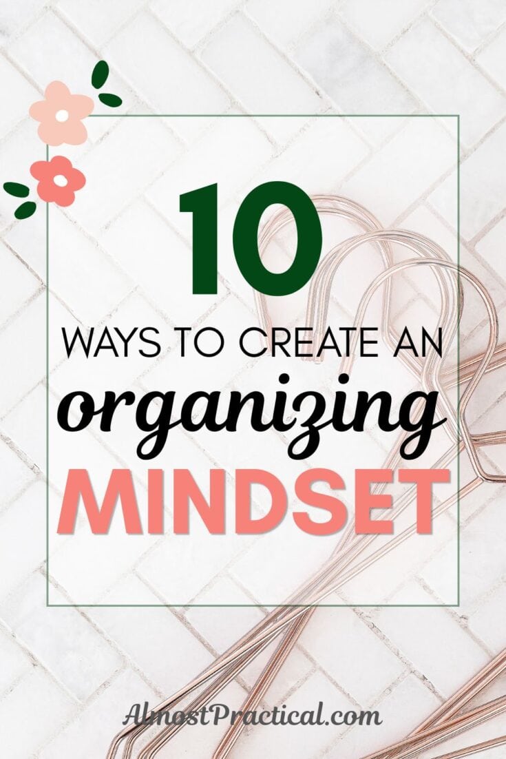 the words "10 ways to create an organizing mindset" superimposed on an image of rose gold metal hangers on a white marble tile background set in a herringbone pattern.