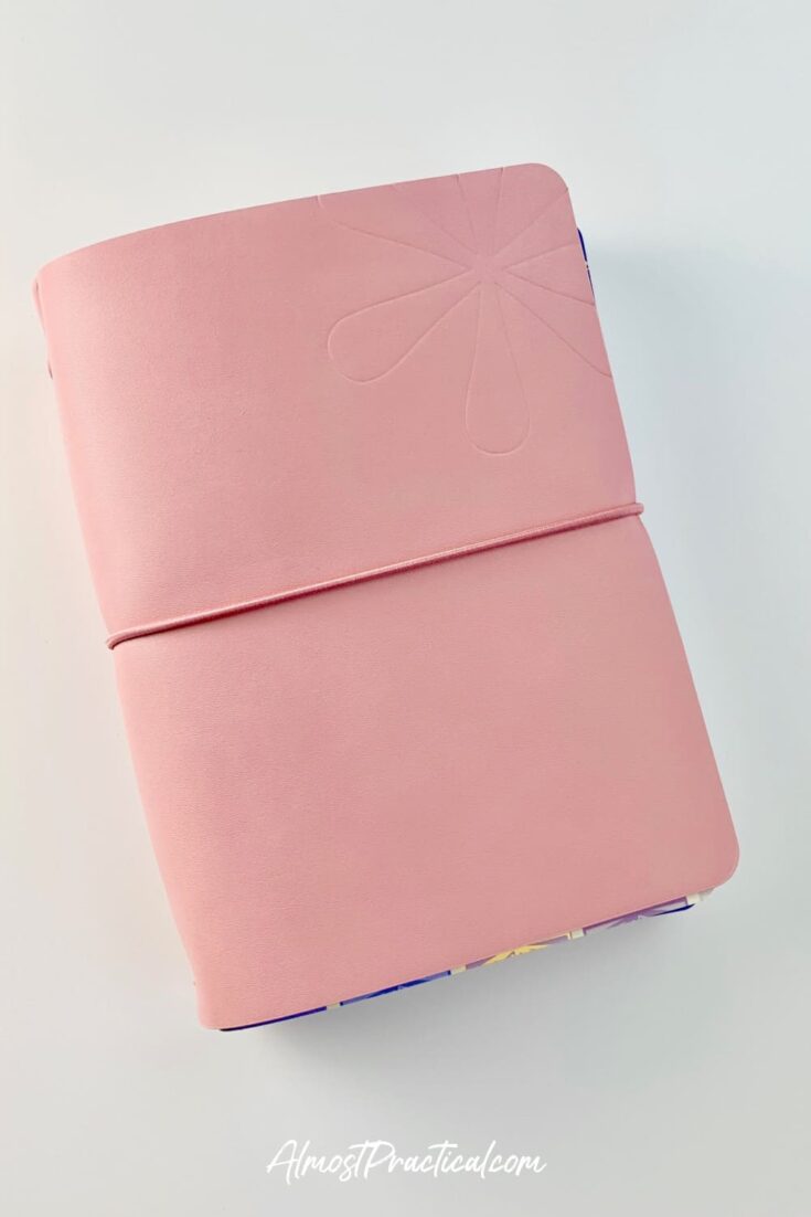 The Erin Condren On the Go Folio in mauve pink filled with Petite Planners.