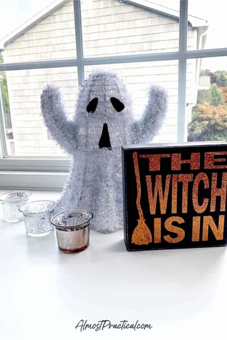 halloween decor - ghost with a "the witch is in" sign