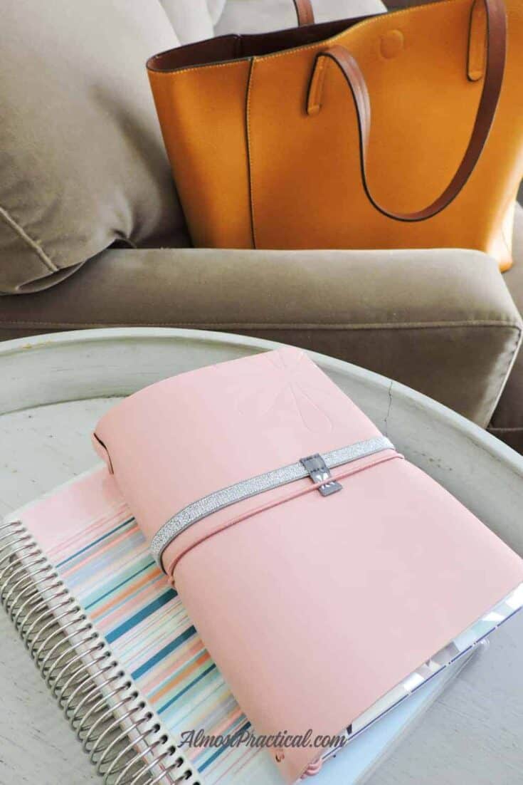 An Erin Condren LifePlanner and Petite Planner on a table in front of a mustard yellow tote bag.