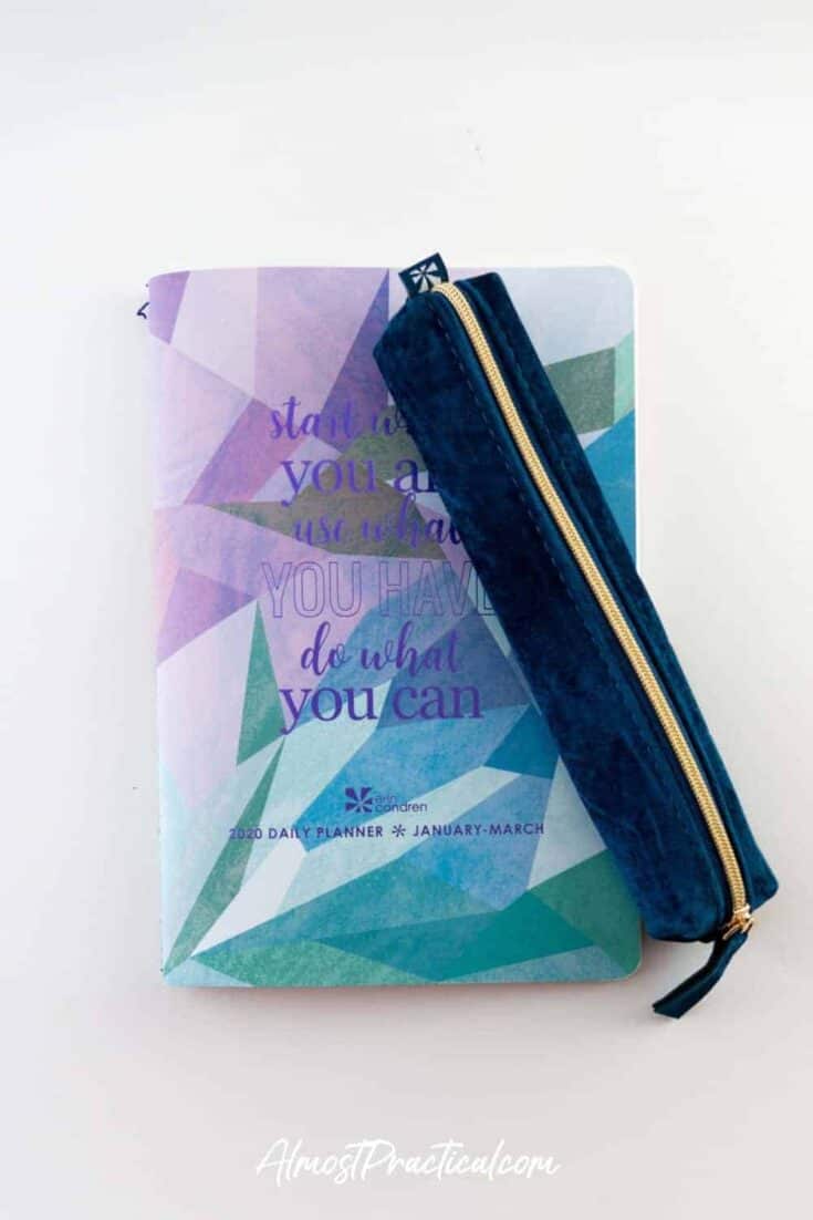 The Erin Condren Sapphire blue velvet pencil pouch on top of one of the Daily Planner Petite Planners.