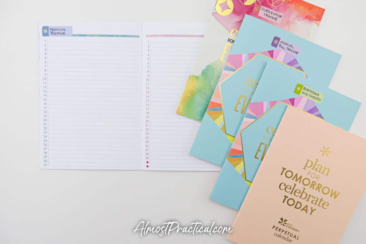A set of Erin Condren perpetual calendars - 4 closed and one open.