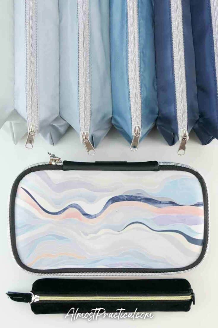 Erin Condren Accordion Pouch in navy, neoprene pencil case in the neutral Layers design, and black velvet pencil pouch with gold zipper.