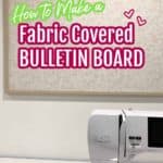 fabric covered bulletin board hanging on wall with sewing machine in foreground