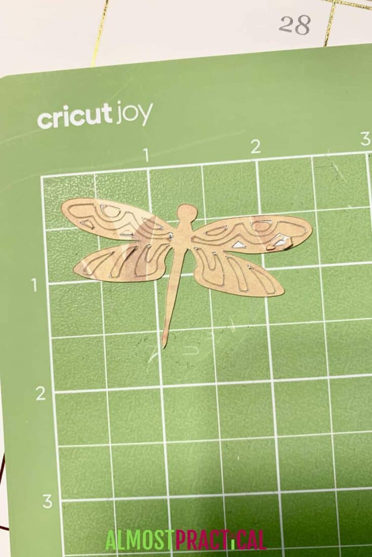 Dragonfly sticker on a Cricut Joy mat.