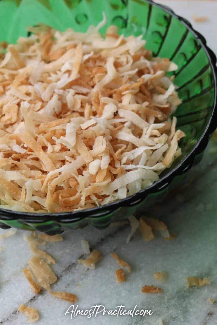 toasted coconut in a vintage green glass bowl