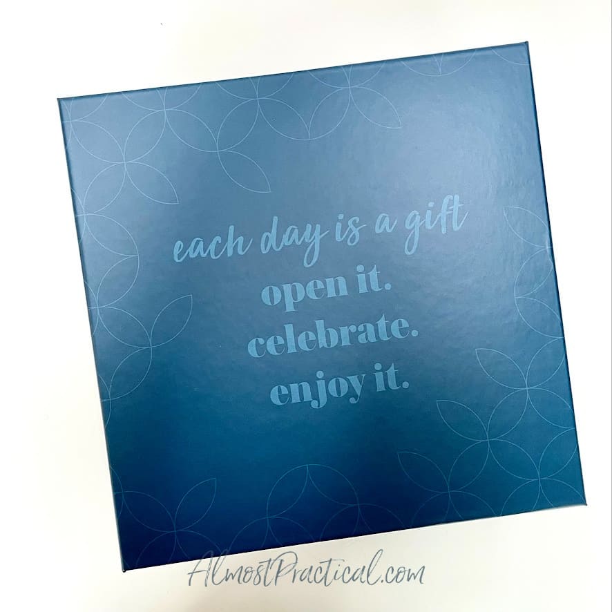 Top of box that says "Each day is a gift - open it. celebrate. enjoy it."