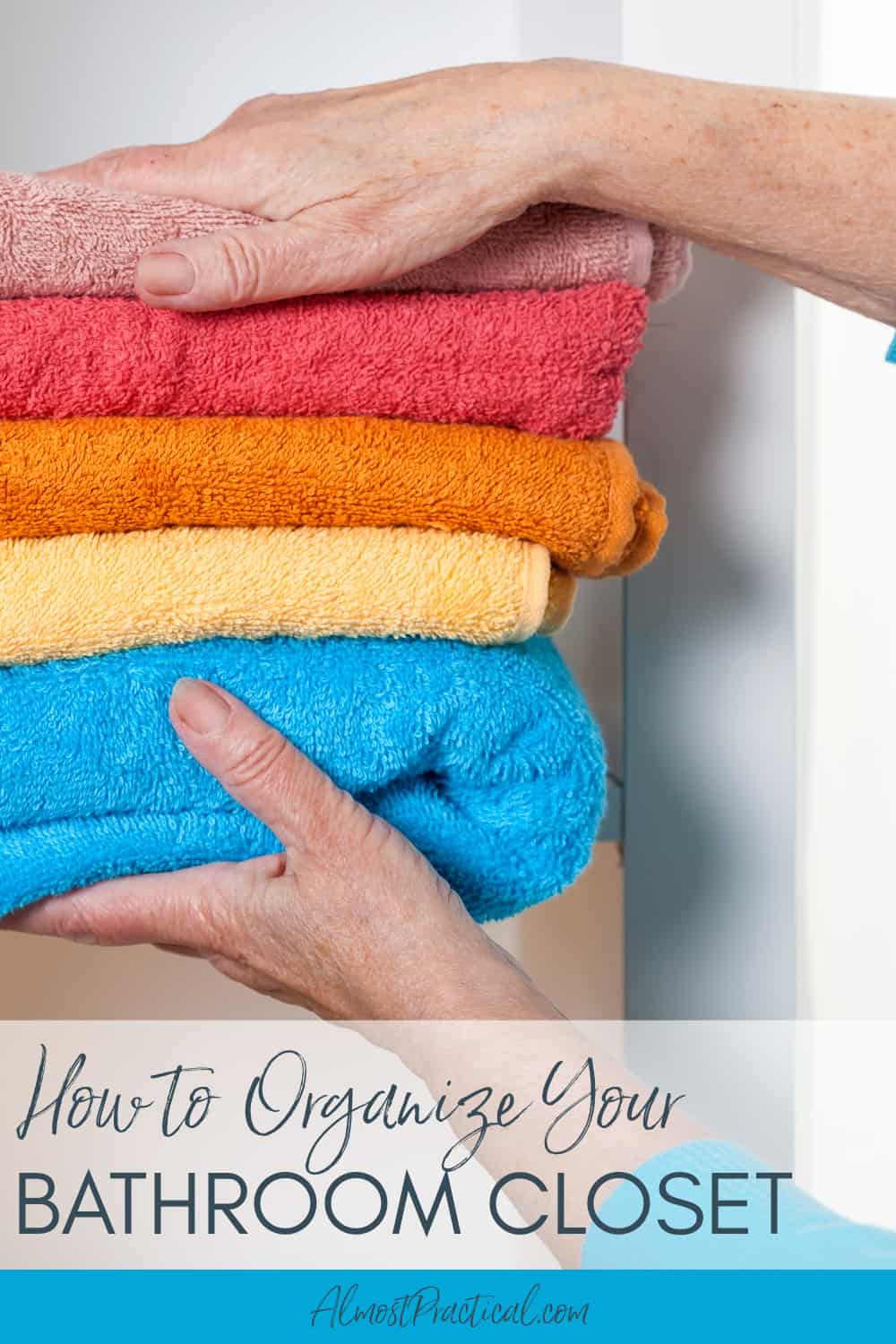 a persons hands placing towels on a shelf