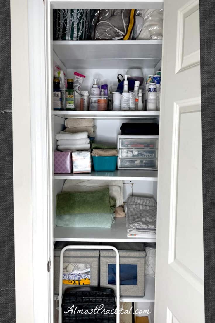 Organized small linen closet.