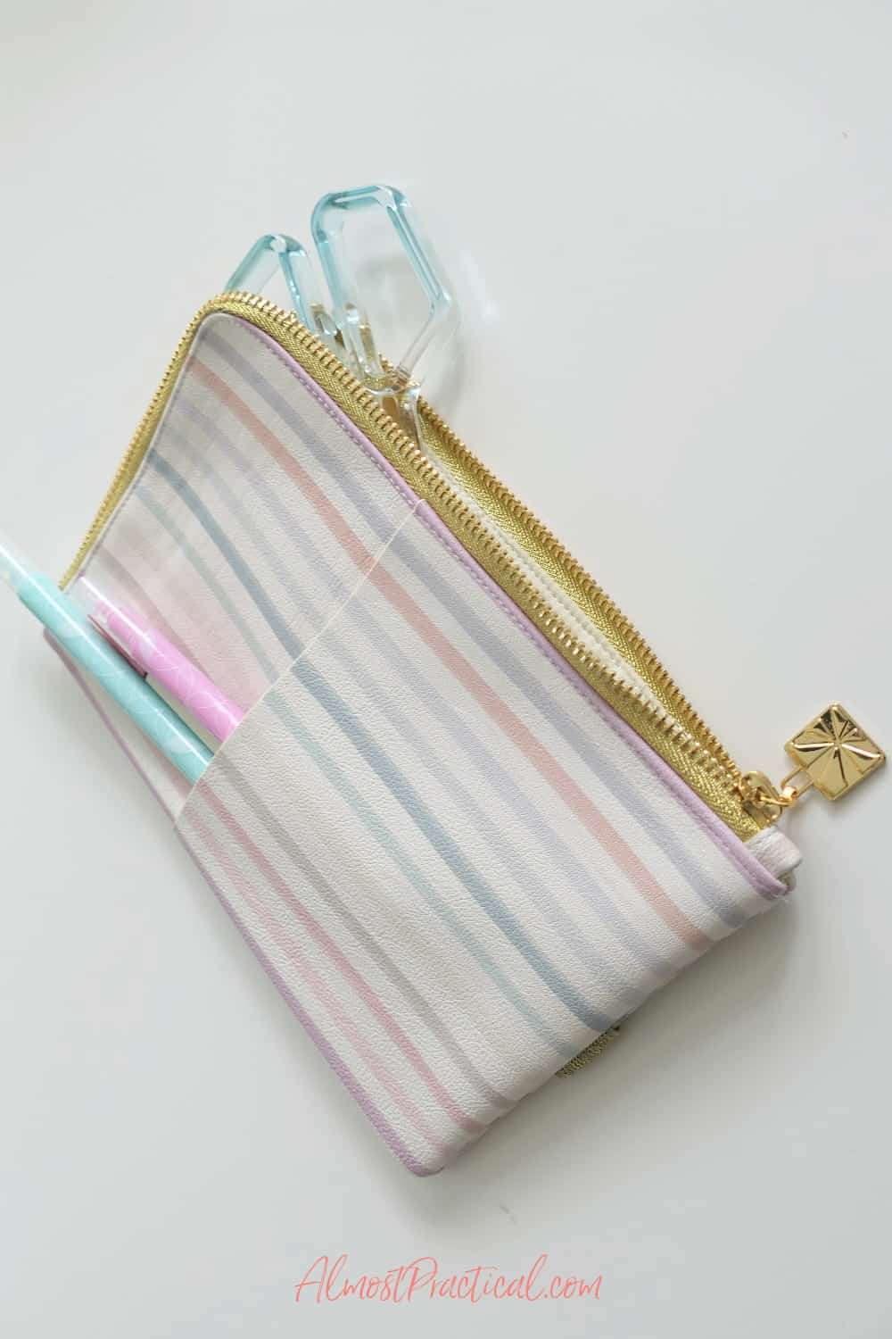 zipper pouch with scissors inside and markers in an outer pocket