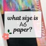 words "what size is A6 paper?" superimposed on a stack of 2 different sized planner books.