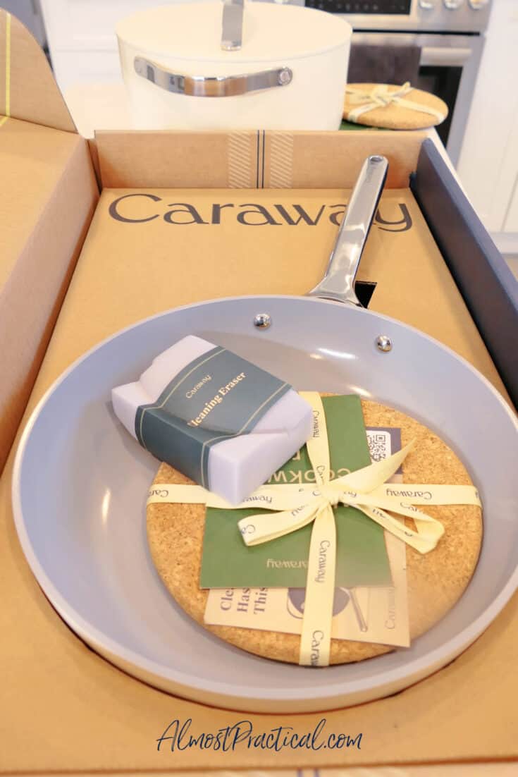 caraway brand fry pan in box with round cork trivet on top