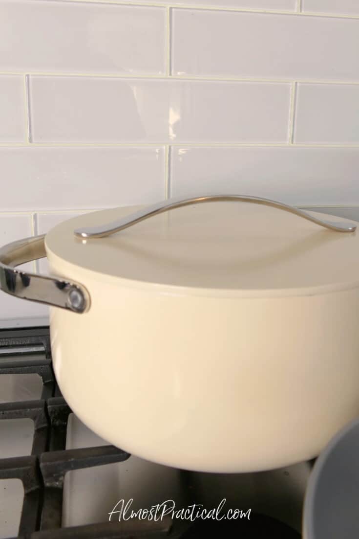 cream color dutch oven with lid on stove