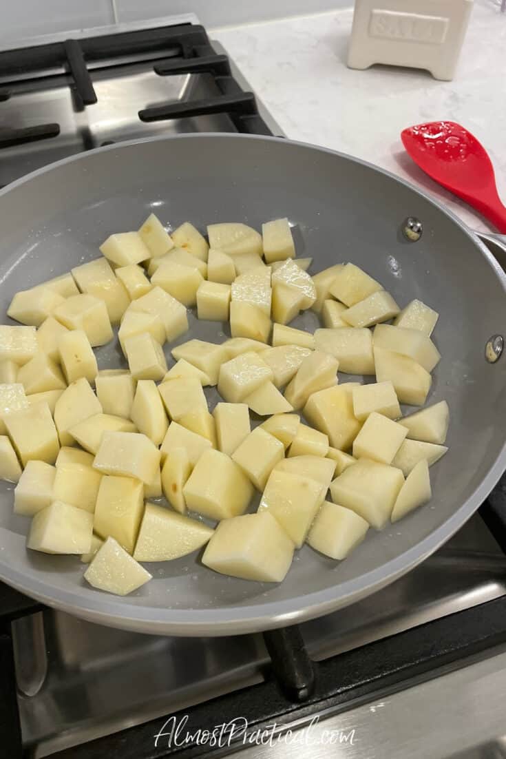 diced potatoes in skillet on stove