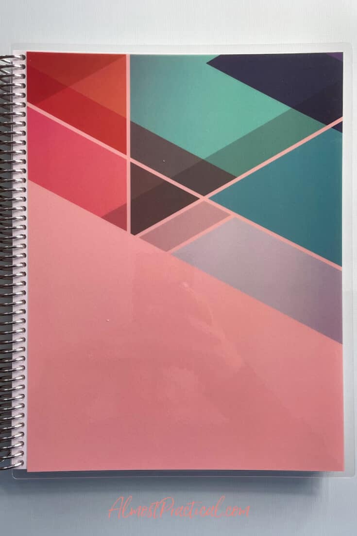 large coiled notebook with cover featuring triangle designs.
