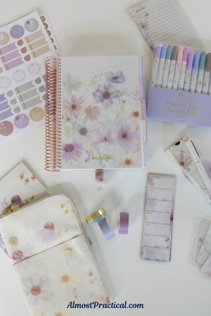 a collection of planners, pens, pouches, and stickers with a floral design