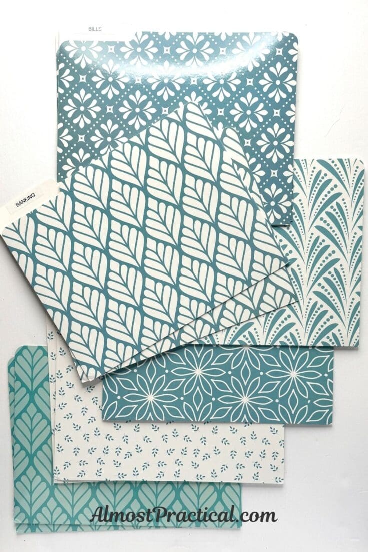 set of decorative file folders that feature teal and cream colored floral designs.