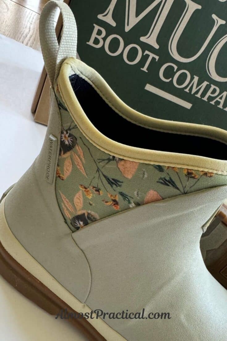 light grey ankle style rainboots with a neoprene insert that has a green and peach floral design