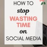 words "how to stop wasting time on social media" super imposed on a photo of a laptop open on a white table with a coffee mug next to it