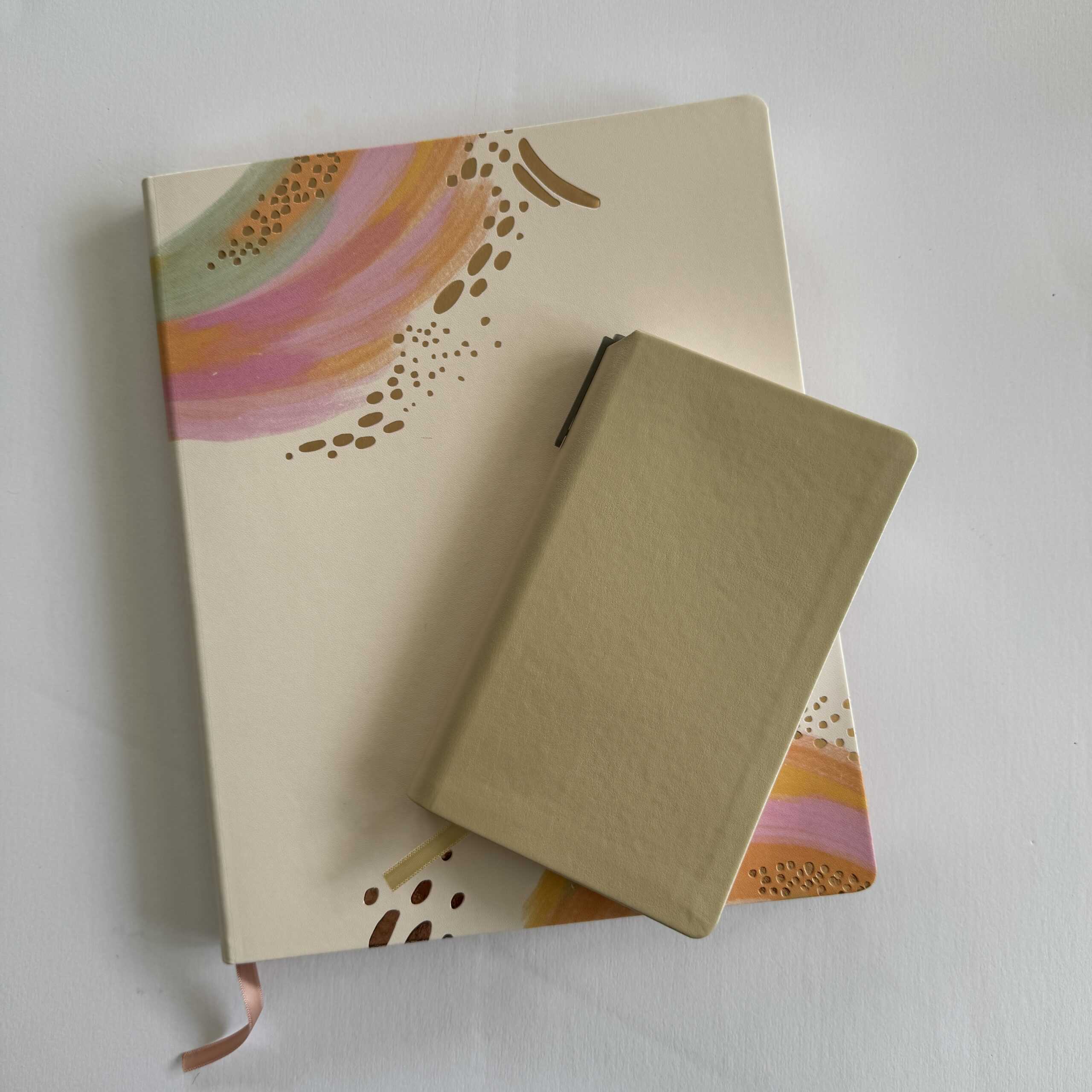 two soft bound planners stacked on top of each other
