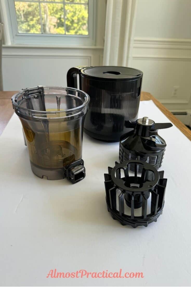 The chamber, hopper, and auger parts of the Hurom H400 slow juicer.