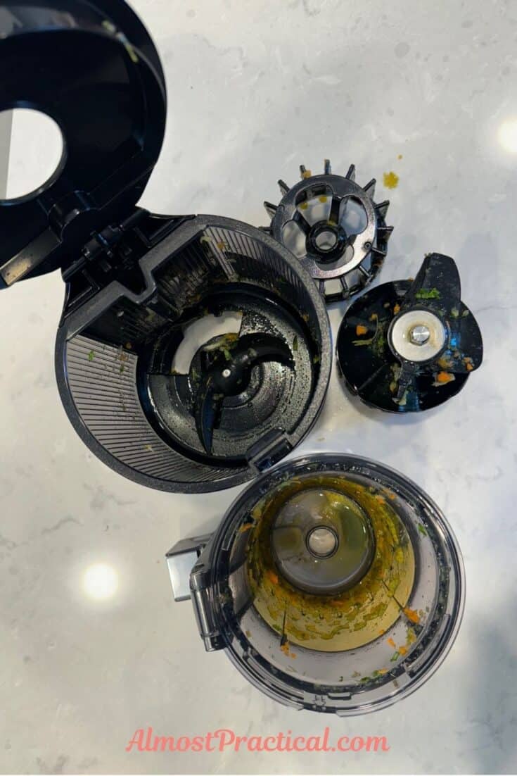 The parts of the Hurom H400 slow juicer after they have been used but before washing.