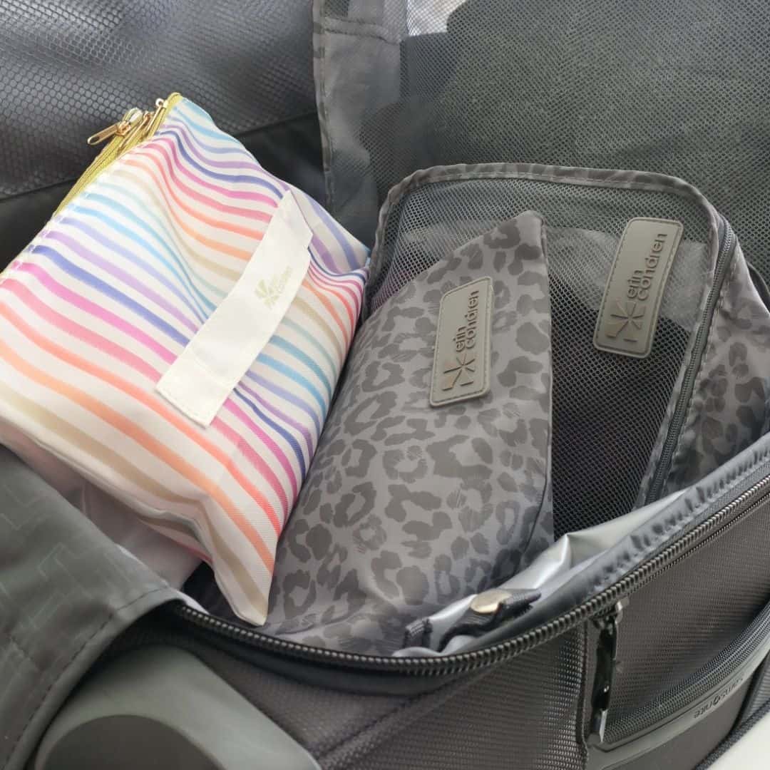 packing cubes in gray leopard print and a colorful strip pouch