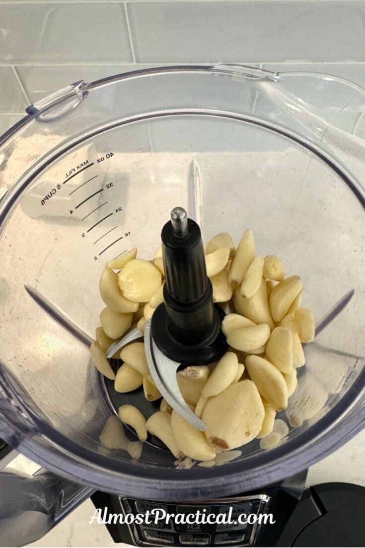 whole garlic cloves in bowl of food processor