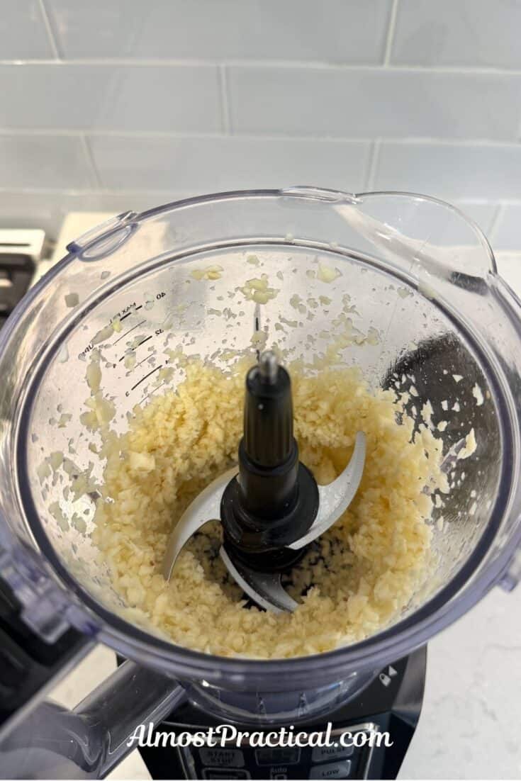 minced garlic in the bowl of a food processor