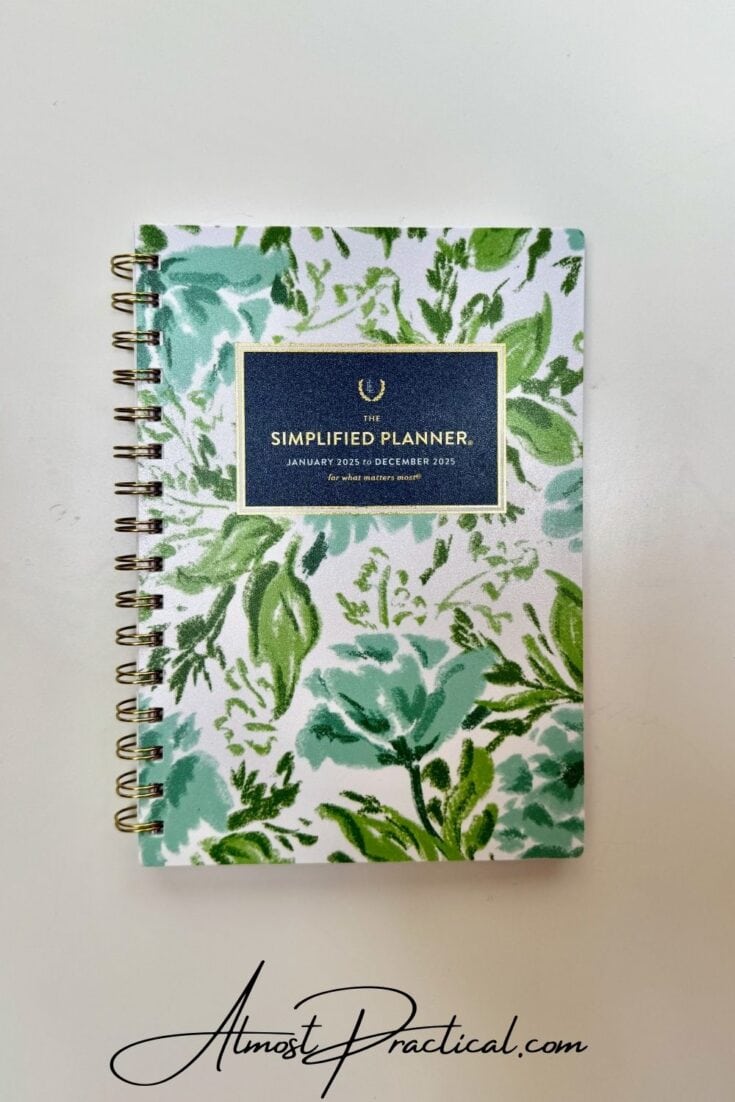 photo of a closed planner with gold coil and pretty green and blue floral design on cover