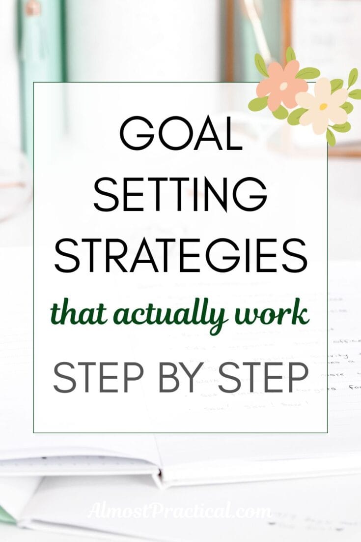 words " goal setting strategies that actually work step by step" superimposed on a photo of an open notebook on a white desk with mint green accessories in the background
