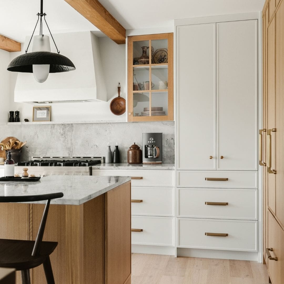 photo of a modern kitchen with white cabinets and wood floor