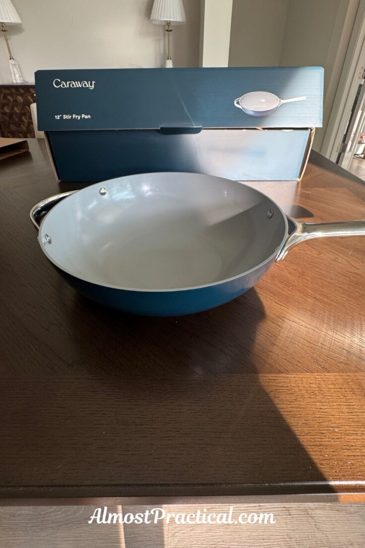 The navy Caraway ceramic coated 12 inch wok shaped stir fry pan.
