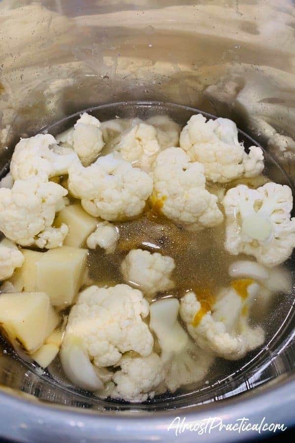 adding the ingredients for the Instant Pot cauliflower soup recipe