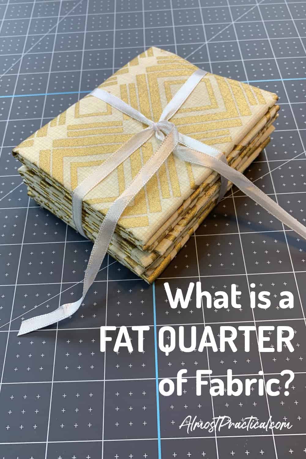 fat quarter stack of fabric in cream and gold tied with a white ribbon