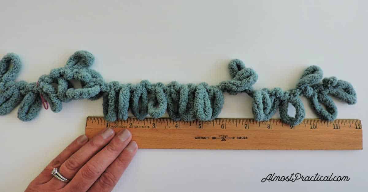 Measuring out the length of the knitting project.